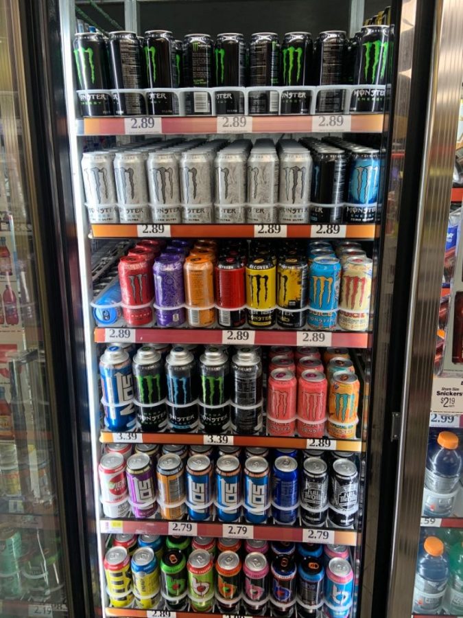 A refrigerator filled with many energy drinks which can be found at 7-Eleven.