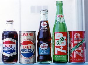 The Diet Pepsi bottle and can are from the late 1960s; Dietetic Dr. Pepper bottle, 1963; Diet 7up bottle, 1969; Diet 7up can, 1970s. I shot this picture in 1997. A mouse in my storage unit ate the label off the Diet Pepsi bottle. :-(