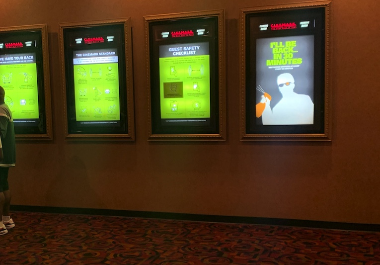Signs that line the halls of the movie theater, giving tips on how to stay safe while enjoying the movie.