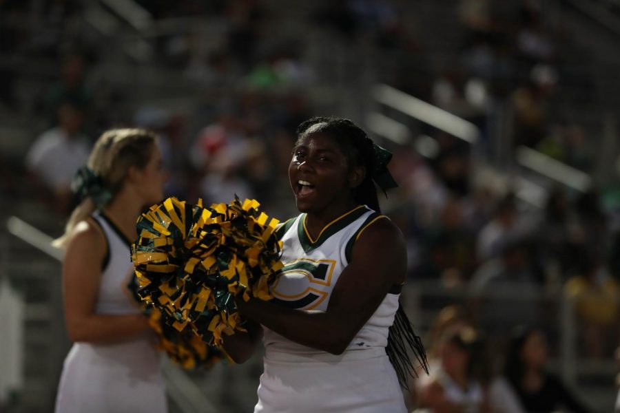 Varsity cheerleader Ebony Lubin cheering on the Cowboys.