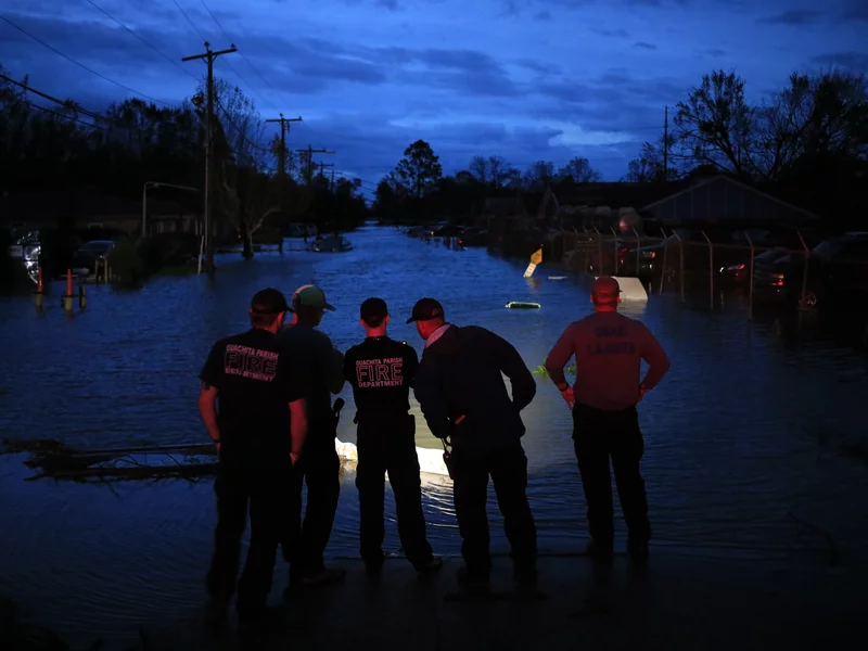 First responders prepare to launch rescue boats to transport residents out of flooded areas of LaPlace, La., on Monday. (Luke Sharrett)