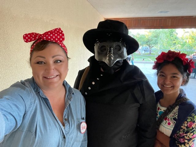 An unlikely trio--Rosie the Riveter (Mrs. Hanks), the plague doctor (Ethan Winchester), and Frida (Bella Franco)--pose for a picture before 2nd period.