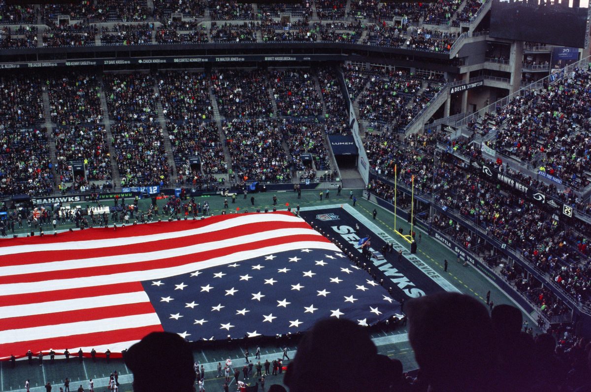 A Large American Flag Displayed In a Stadium