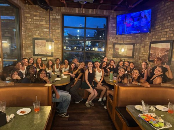Photo of the Girls Tennis Team at Toppers Pizza after JV's win.

