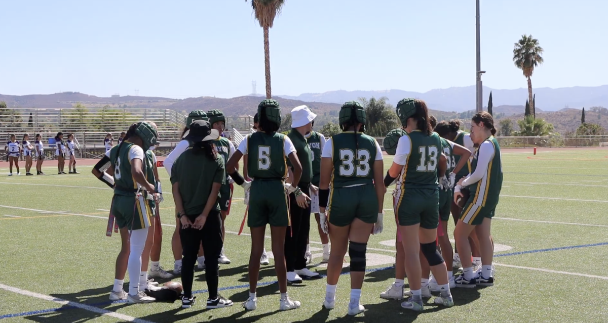 Varsity Girls Flag Football huddled around during a game against Valencia on Aug. 20.