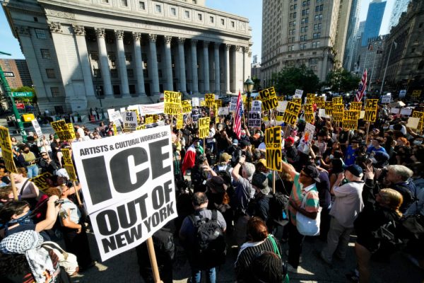 People protesting against federal immigration sweeps in New York City.