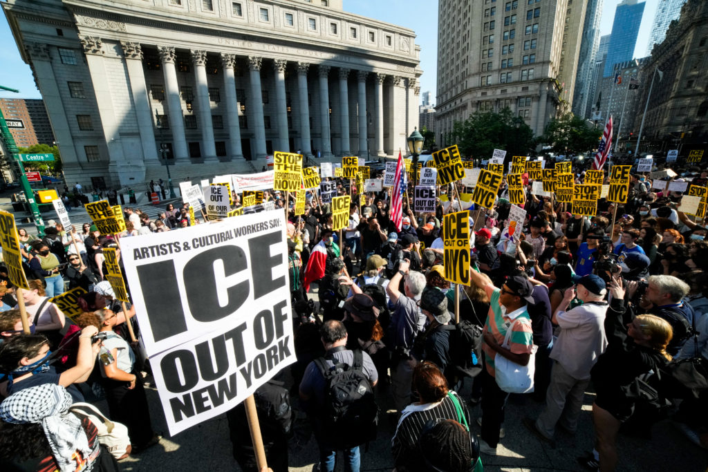 People protesting against federal immigration sweeps in New York City.