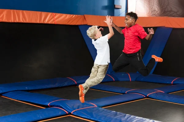 Two kids jumping and enjoying the trampolines at Sky Zone!