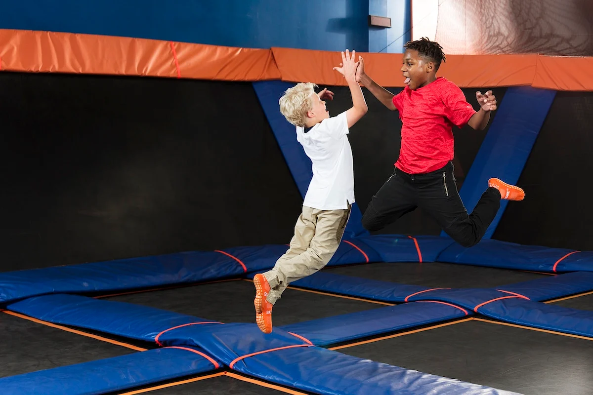 Two kids jumping and enjoying the trampolines at Sky Zone!